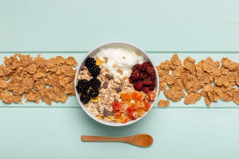 High-Protein Bariatric Snacks: a bowl of yogurt with granola, berries and dried fruit between two rows of cereal clusters